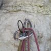 Locking carabiner and ropes on a climbing wall