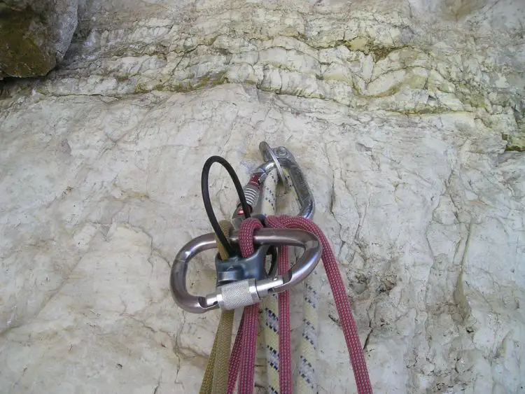 Locking carabiner and ropes on a climbing wall
