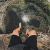 A man climbing a mountain barefoot