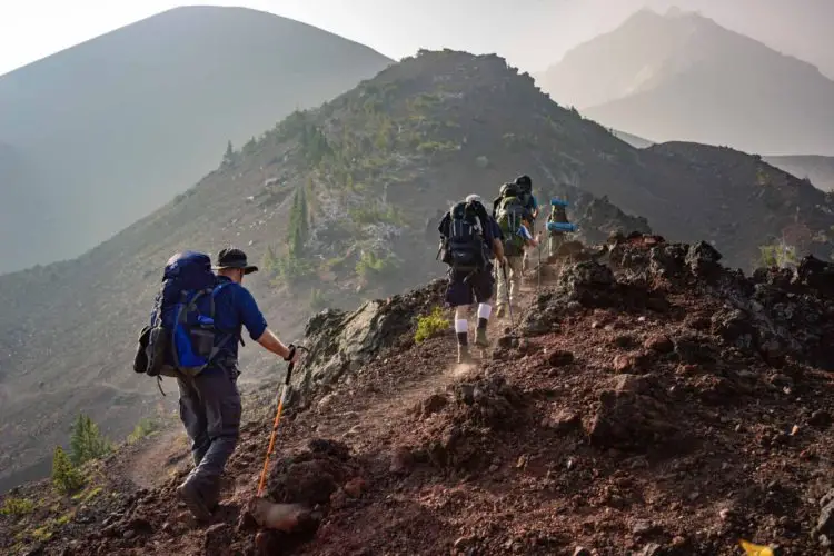 5 hikers hiking on a mountain to improve their stamina