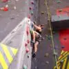 Man climbing indoor (bouldering) wondering how high the climbing wall is